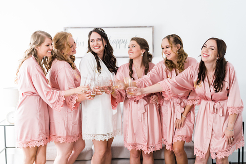 Marrier and attendants in matching robes toast with champagne - 48 Fields Wedding Barn | Northern VA