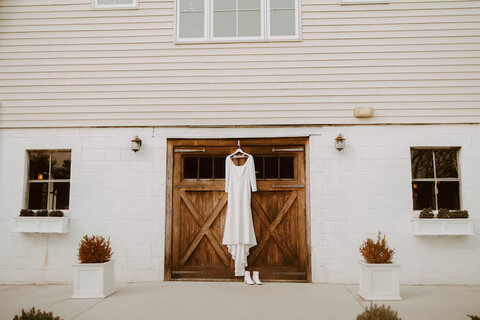 wedding dress on barn door fall wedding - 48 Fields Wedding Barn | Leesburg VA