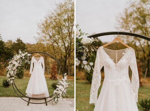 long sleeve lace wedding dress hanging on floral ring - 48 Fields Wedding Barn | Leesburg VA